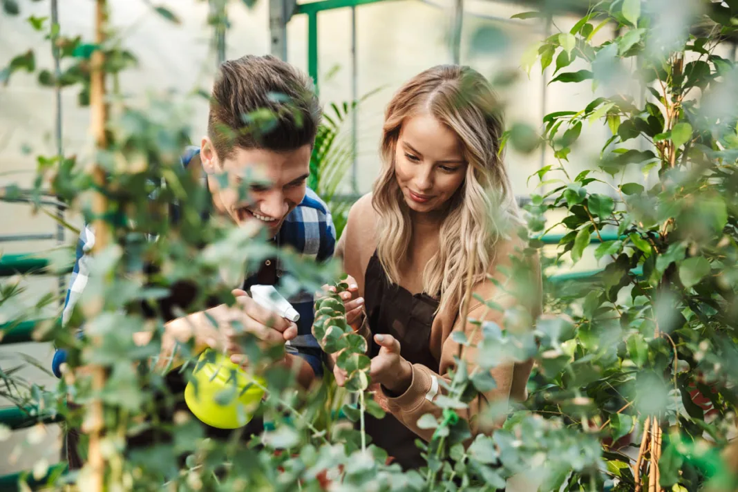 Image,of,two,amazing,gardeners,posing,in,the,nature,greenhouse