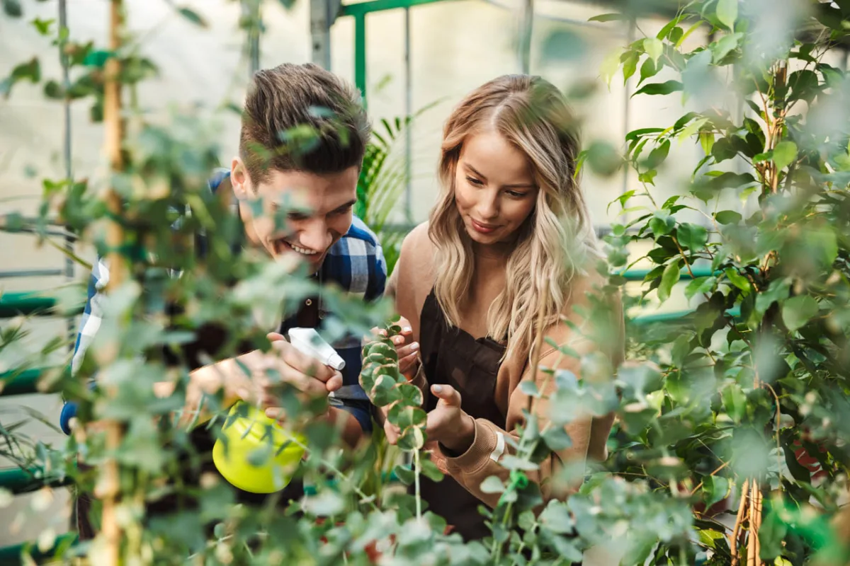 Image,of,two,amazing,gardeners,posing,in,the,nature,greenhouse