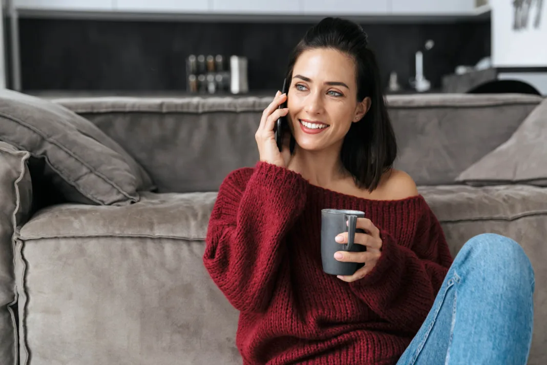 Image,of,a,beautiful,woman,indoors,in,home,near,sofa